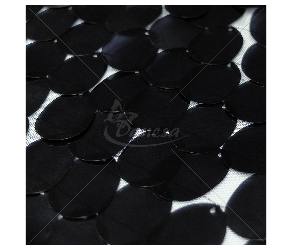 The fabric is embroidered with large scales