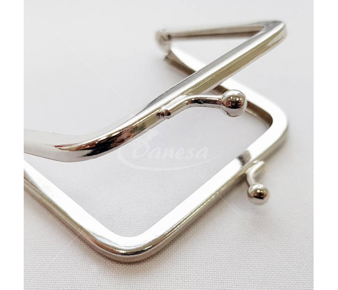 Metal fittings for handbags, wallets and purses