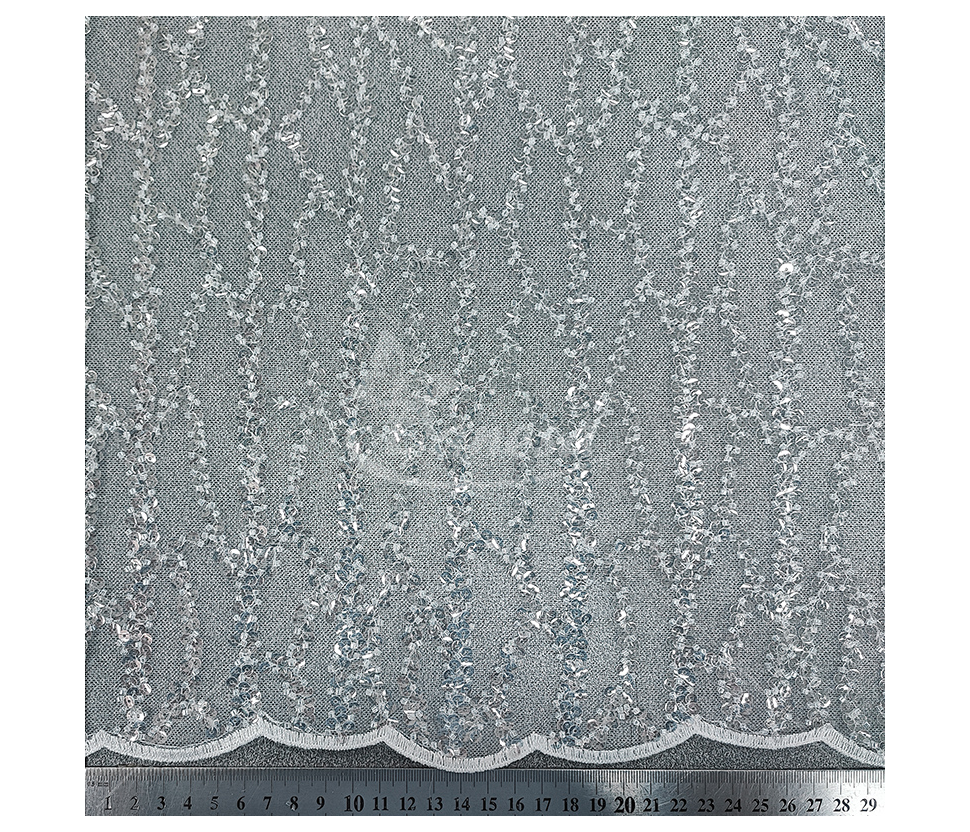 Fabric embroidered with scales