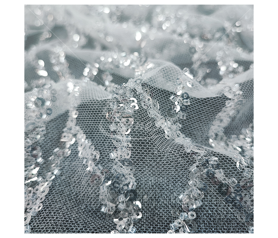 Fabric embroidered with scales