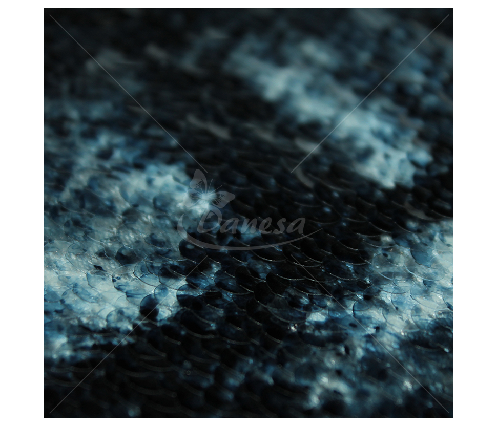 Fabric embroidered with scales